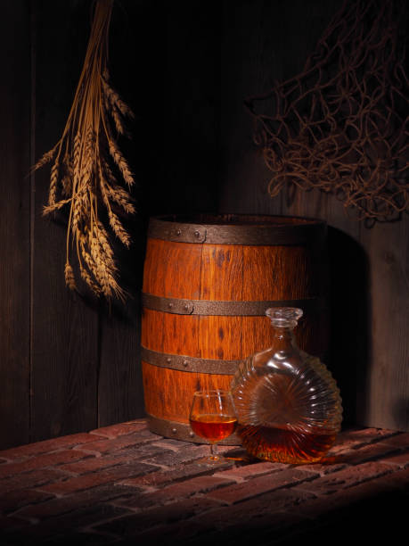 istock Glass of cognac with barrel in cozy cellar 853902316
