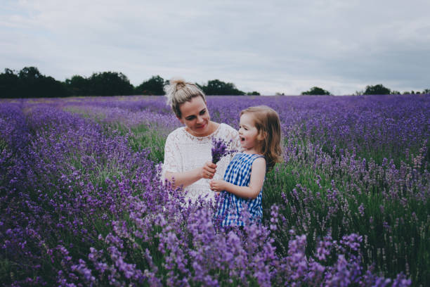 istock Mom and daughter in lavender. 853902746