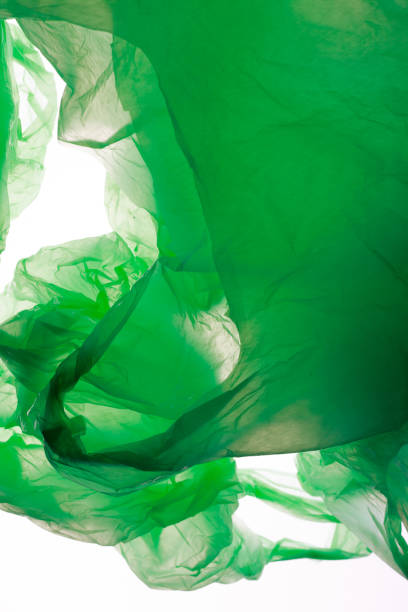 istock Crumpled green plastic bags isolated on white. 853903608