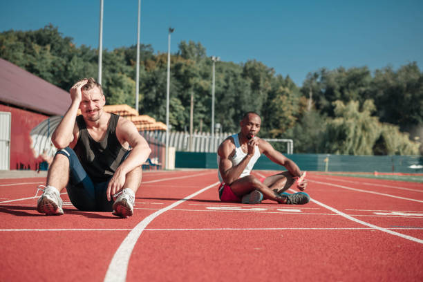 istock Athlete sits and suffers at the stadium 853908972