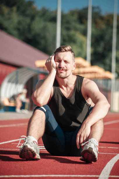 istock Athlete asleep sitting in the stadium 853908980