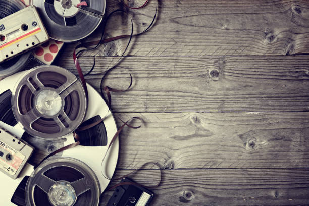 Old audio reels and cassette tape background Retro audio reels and cassette tape with copyspace reel to reel tape stock pictures, royalty-free photos & images