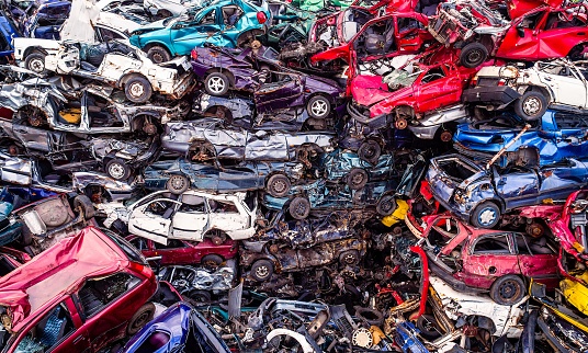 Scrapped cars stacked on a scrap yard. Car recycling