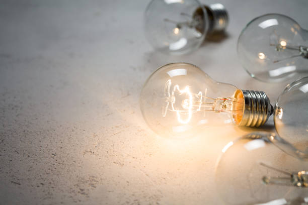 istock Group of vintage bulbs on concrete background 853916392