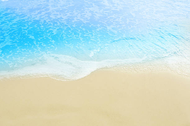 istock sea water wave foam coming on the white clear sandy beach 853916946
