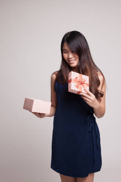 istock Young Asian woman open a gift box. 853919492