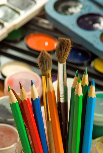 istock image of paints and colored pencils close-up 853920144