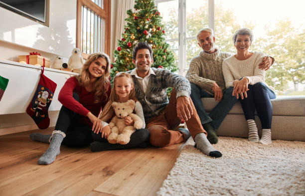 istock Family holiday gathering by Christmas tree 853923786