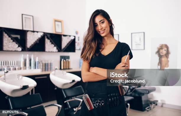 Female Hairdresser Standing In Salon Stock Photo - Download Image Now - Hairdresser, Hair Salon, Beauty Spa