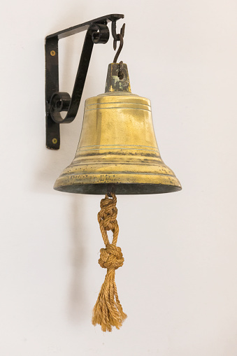 An old-fashioned ship's bell made of brass.