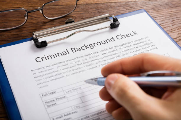 istock Person Filling Criminal Background Check Application Form 853927282