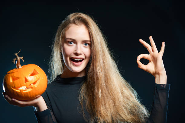 istock Woman with Halloween pumpkin gesturing OK 853927554