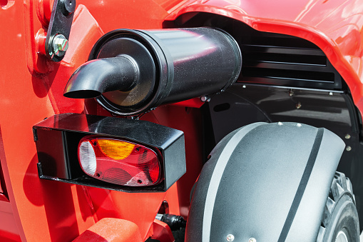 rear lights and exhaust pipe on the tractor or excavator. Details of construction equipment