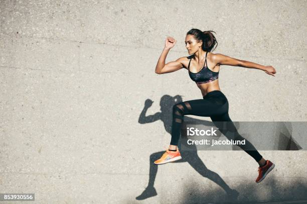Fit Young Woman Jumping And Running Stock Photo - Download Image Now - Women, Running, Exercising