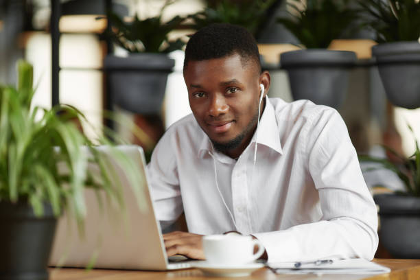 istock African student typing at laptop working in restaurant 853931592