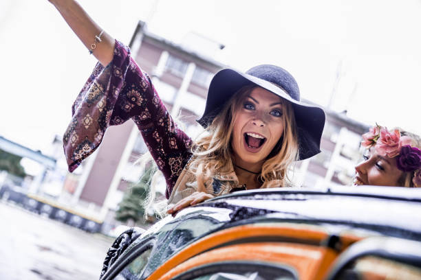 istock Girls in a convertible car 853931666