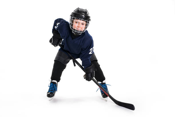 young boy in ice hockey gear against white - teamsport imagens e fotografias de stock