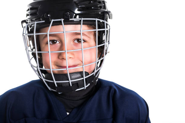 young boy in ice hockey gear against white - teamsport imagens e fotografias de stock