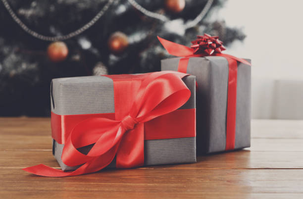 istock Christmas gifts on decorated tree background, holiday concept 853935532