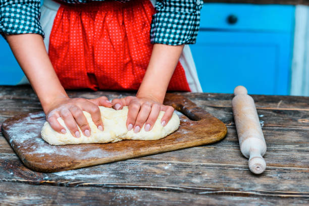 istock woman kneading dough 853935846