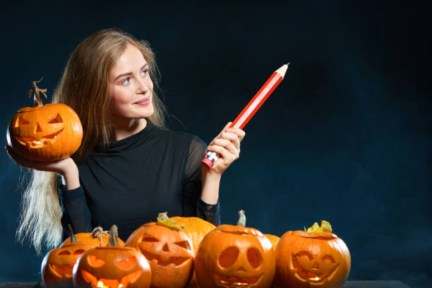 istock Woman with Halloween pumpkins 853939676
