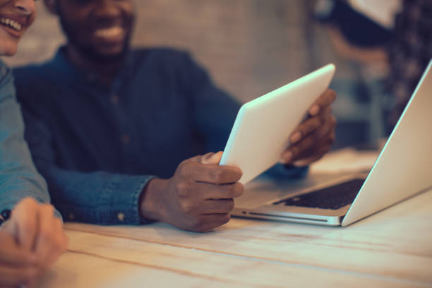 istock Young man and woman working on a digital tablet 853940076