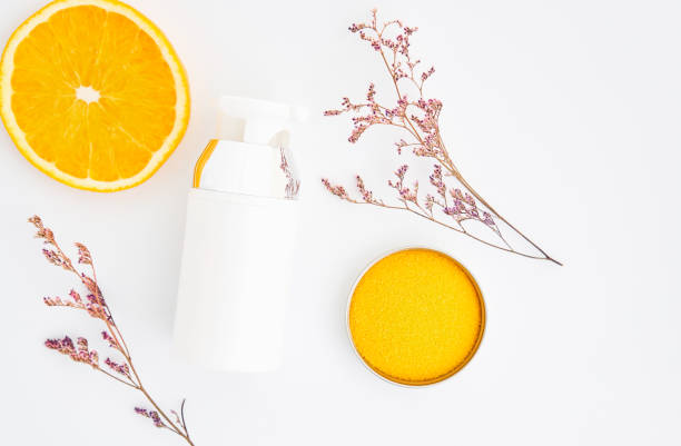 istock bottle placed, Blank label package for mock up on white background and flowers. The concept of natural beauty products. 853940432