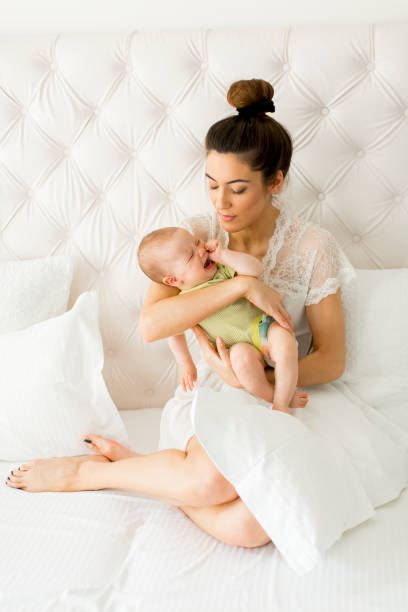 istock Young mother holding her litle crying daughter 853943230