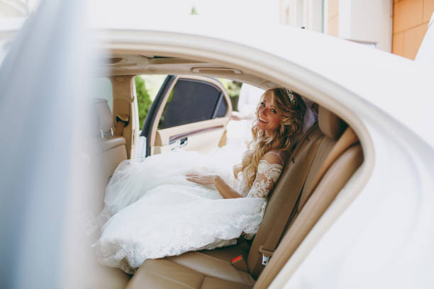 istock Beautiful blond bride gets into the car 853943576