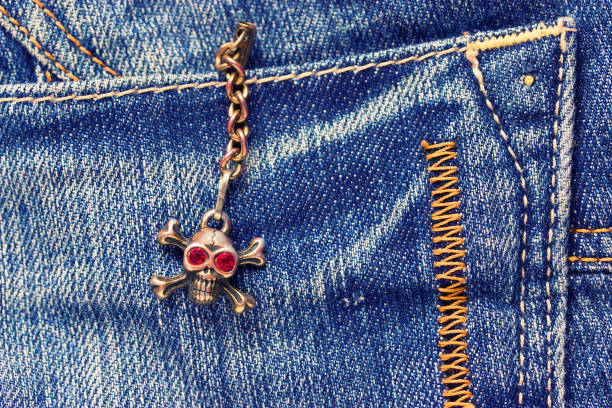 istock Skull brooch on torn jeans . 853943860