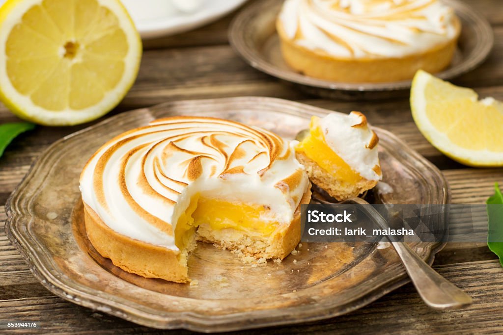 Mini lemon meringue pies Mini lemon meringue pies with tea Sweet Pie Stock Photo