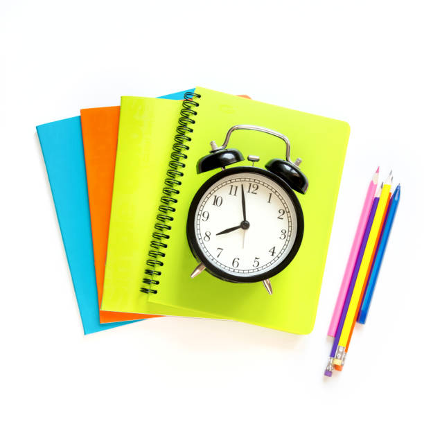 istock Colorful school supplies and alarm clock on white. Top view, flat lay. Square image. 853951568