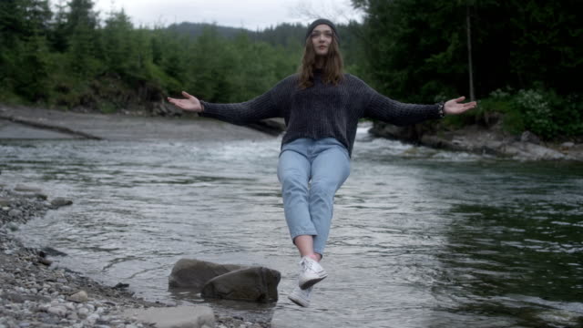 Magic in nature. Woman levitating above the stream