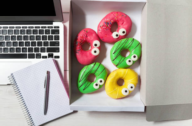 istock Business lunch snack in office, glazed donuts box top view 853952612