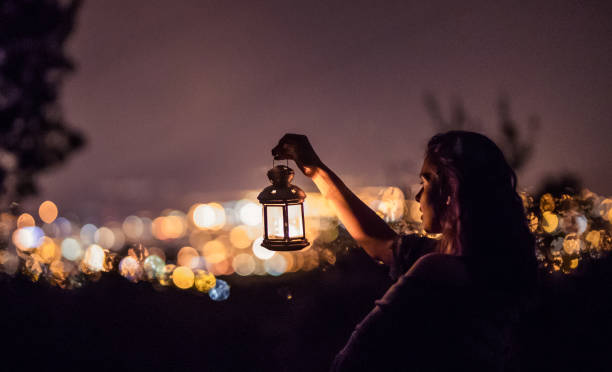 istock Woman with lantern at night 853956396
