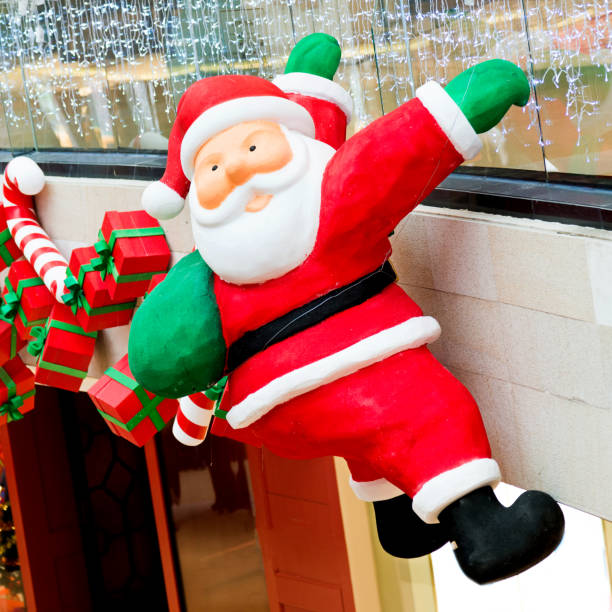 istock Santa claus pupper is climbing up a house 853956616