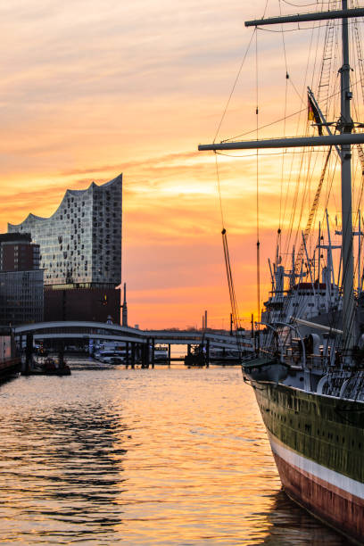 A sunrise in the harbour of Hamburg The Elphi between old ships in the harbour of Hamburg elbphilharmonie photos stock pictures, royalty-free photos & images