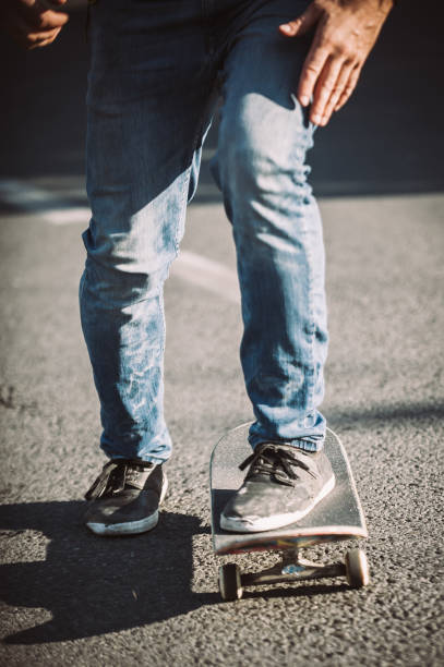 istock Skateboarder legs riding skateboard on the street 853959950