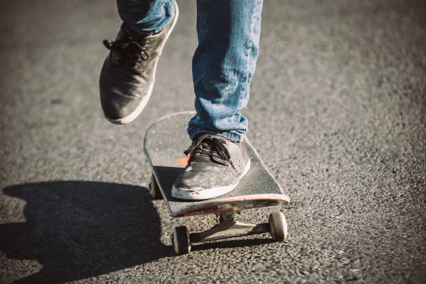 istock Skateboarder legs riding skateboard on the street 853960210
