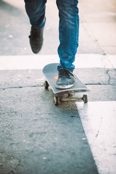 istock Skateboarder legs riding skateboard on the street 853963210