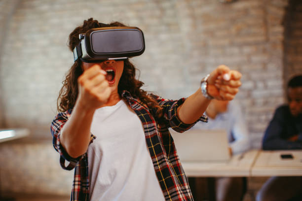 istock Young woman have fun with Virtual Reality VR Headset in the office 853963590