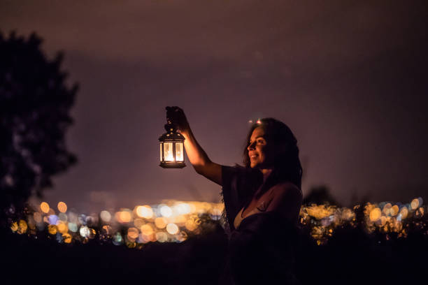 istock Woman walking through the night with lantern 853964588