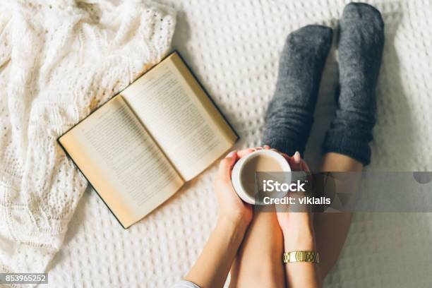 Woman Laying In Bed And Read Book With Cup If Coffee Stock Photo - Download Image Now