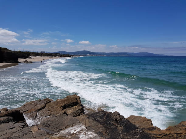 istock sunny sky at rock beach in Galicia 853965612