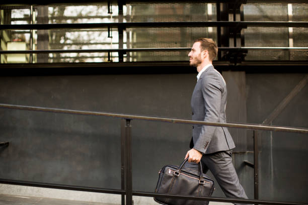 istock Businessman in suit with leather handbag goes to work 853965838