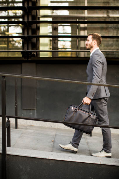 istock Businessman in suit with leather handbag goes to work 853965846