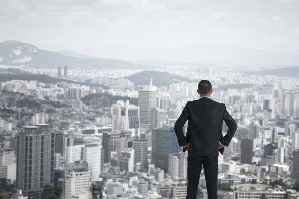 istock man in suit looking to cityscape,Business concept 853969018