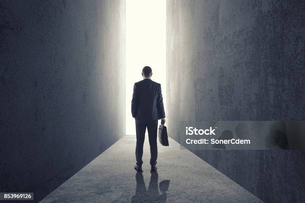 Silhouette Of Businessman Entering Giant Doorway Stock Photo - Download Image Now - Leaving, Business, Businessman