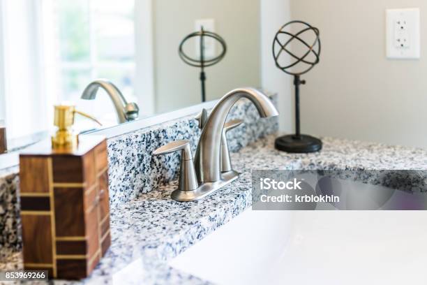 Closeup Of Modern Bathroom Sink With Granite Countertop Mirror Soap Dispenser Pump And Faucet In Staging Model Home Apartment Or House Stock Photo - Download Image Now