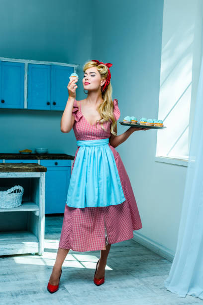 istock pin up housewife with cupcakes 853969860